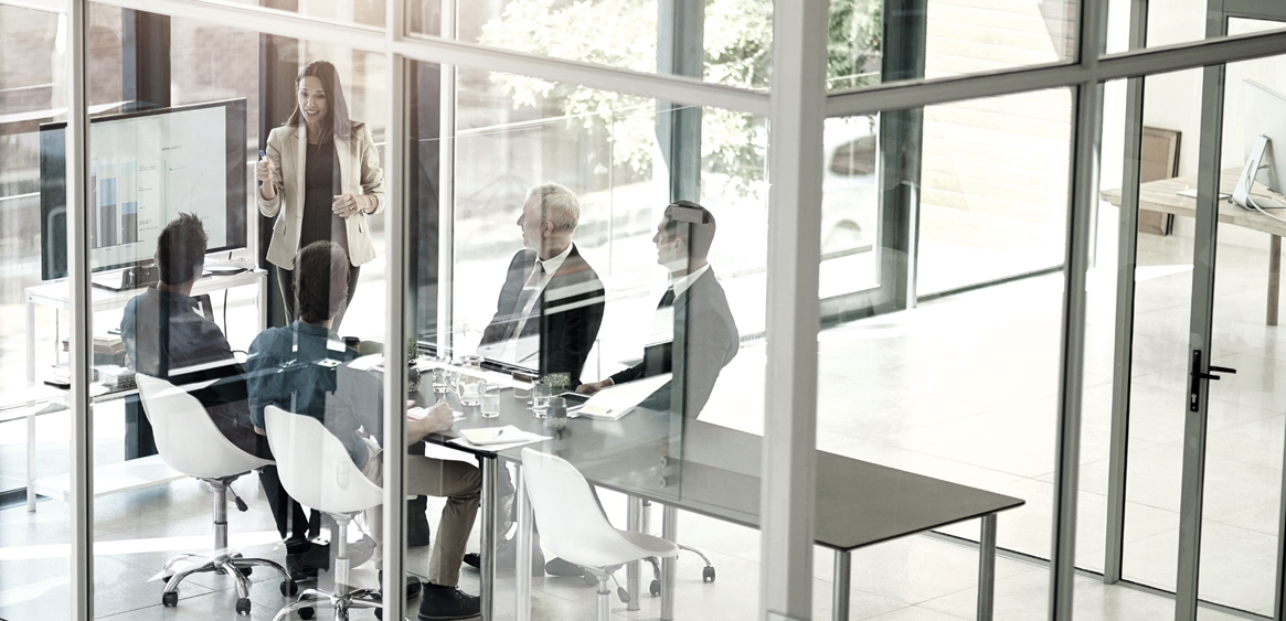 A team meeting in a glass-walled conference room